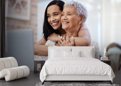 Its those little moments in life. Shot of a senior woman using a laptop with her daughter at home. Wall mural