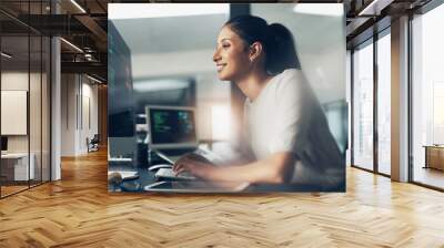 Life as a coder. Shot of a woman using a computer in a modern office. Wall mural