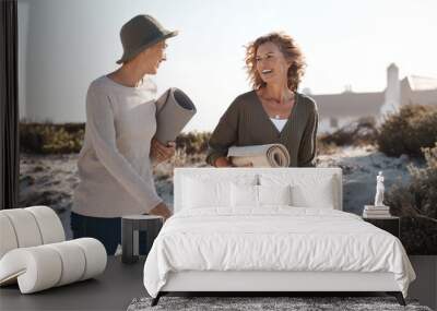 Loving life on the beach. Cropped shot of two attractive mature woman walking with their on the beach. Wall mural