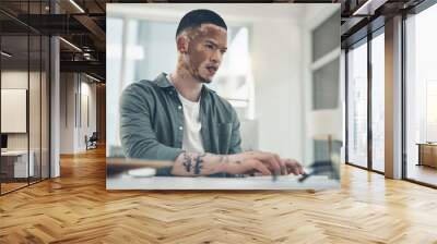 Opportunities dont happen. You create them. Shot of a young business man working in a modern office. Wall mural