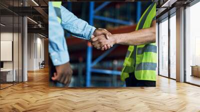 Proud to have a reliable partner like you. Shot of two builders shaking hands at a construction site. Wall mural