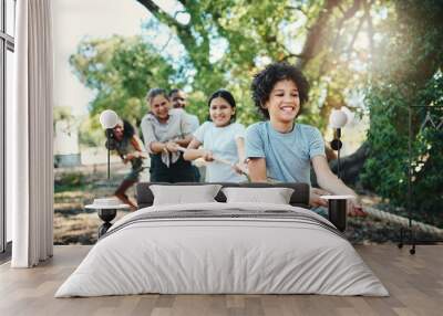 Pull harder team. Shot of a group of teenagers playing a game of tug of war at summer camp. Wall mural