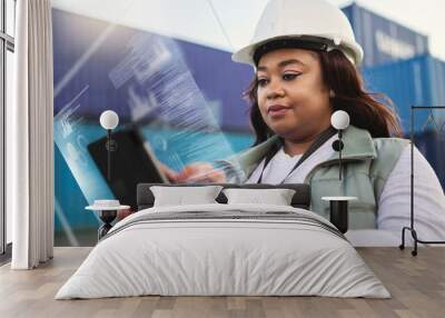 Supply chain, tablet and futuristic with a black woman logistics worker busy on a ux dashboard for online order. Digital, shipping and delivery with a courier at work on a container yard with overlay Wall mural