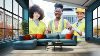 Supporting greater diversity to ensure the greatest success. Portrait of a group of confident young businesswomen working at a construction site. Wall mural