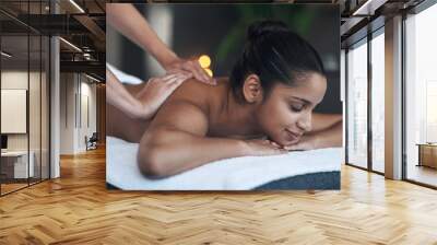 The best days are spa days. Shot of a young woman getting a back massage at a spa. Wall mural