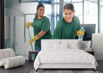 The deepest clean for complete peace of mind. Shot of two young woman cleaning a modern office. Wall mural