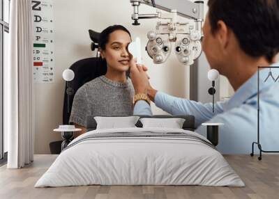 What can you see when I do this. Shot of an optometrist covering her patients eyes with an occluder during an eye exam. Wall mural