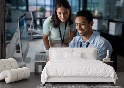 Winners make a way to make it work. Shot of a young businessman and businesswoman using a digital tablet in a modern office. Wall mural