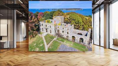 Aerial over old abandoned stone structure in great condition with Maine ocean in background Wall mural