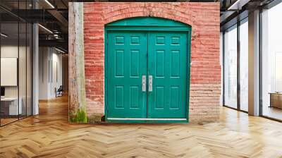 Green double doorway on red brick wall Wall mural