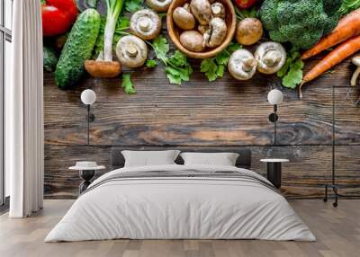 organic harvest vegetables from garden and forest mushrooms vegetarian ingredients for cooking on dark rustic wooden background top view border Wall mural