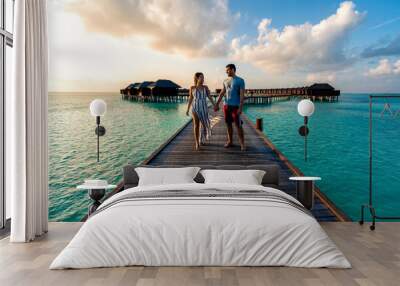 A couple enjoying a sunrise in the Maldives.   Wall mural