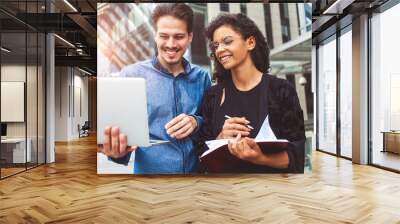 Business people talking at street using a laptop Wall mural