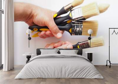 Painter man's hands with painting brushes Wall mural