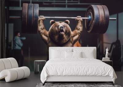 Bear holding a heavy barbell aloft above his head in a gym, overhead press Wall mural