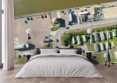 defaultDrone photography of a holiday park near an inland waterway on the Suffolk coast. Car parking and a lifeboat station can be seen. Wall mural