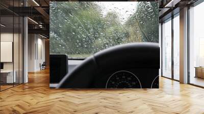 Drivers view of a heavy downpour seen will parking up in a luxury, german-built sports car. Wall mural