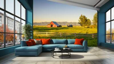 Summer sunset with a red barn in rural Montana and Rocky Mountains Wall mural