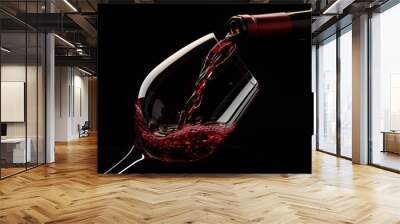 Red wine pouring to bordeaux glass on table pure black background Wall mural