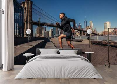 Athelte man running in New York City street wearing sport clothes Wall mural