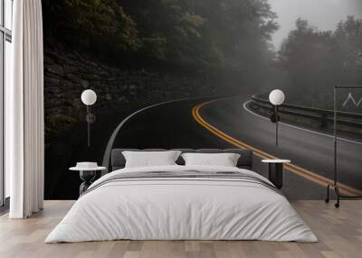 Mountain wet asphalt road curve at fog rainy day Wall mural