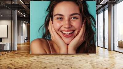 Young man happy smile chin rest on both hands long hair Caucasian female in tank top close up light grey background Wall mural