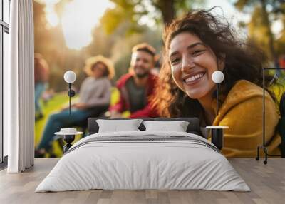 Cheerful people in wheelchair in a park at golden hour. Disabled person friendship. Wall mural