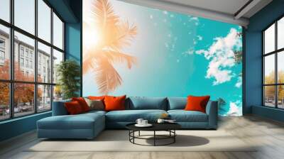 Green palms against blue sky background as vacation and summer holidays concept with copyspace for travel agency advertising campaign Wall mural