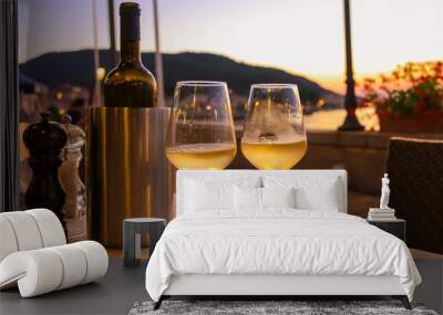 Bottle of white wine and two glasses on the restaurant table on Wall mural