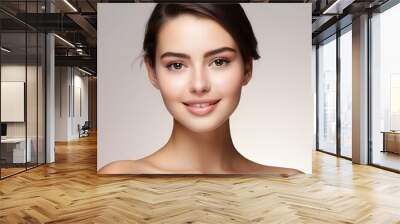 Portrait of a beautiful young woman bright skin on studio background Wall mural