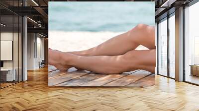 Woman's beautiful legs on the beach Wall mural