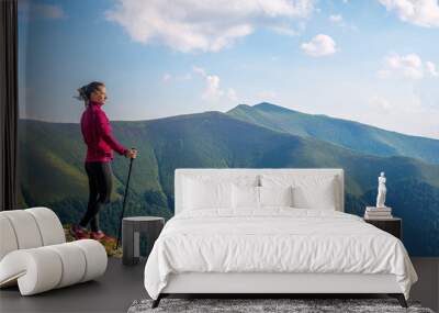 Young woman hiking in the mountains Wall mural