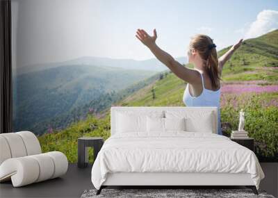 Young woman meditate on the top of mountain Wall mural