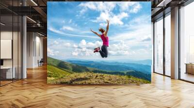 Young woman on the top of mountain Wall mural