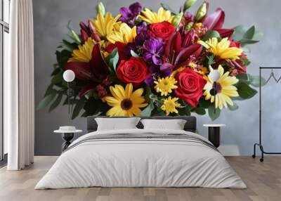 A bouquet of flowers with a mix of bright red roses, yellow daisies, and purple lilies. Wall mural