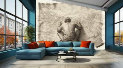 A classic engraving of a 17th-century explorer charting new lands on a detailed map.  Wall mural