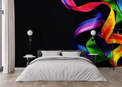 A colorful ribbon is shown on a black background. The ribbon is long and has a rainbow pattern. Pride Month Concept Wall mural