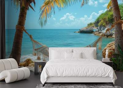 A hammock tied between two palm trees, gently swaying with the ocean in the background.  Wall mural