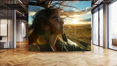 A woman with long hair is driving a car and looking out the window Wall mural