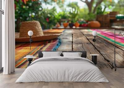 A wooden table with a colorful tablecloth and a straw hat on top of it. Dia de los Muertos or Cinco de Mayo Celebration Wall mural