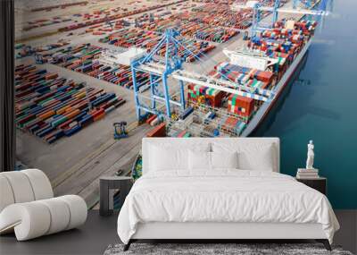 Container ship being loaded and unloaded at terminal freight port, international shipping and global commerce, modern cargo harbor and yard for maritime shipment and delivery, worldwide transport. Wall mural