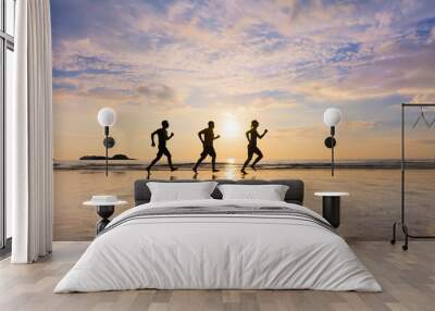 Group of joggers running on a beach, healthy lifestyle, sport Wall mural