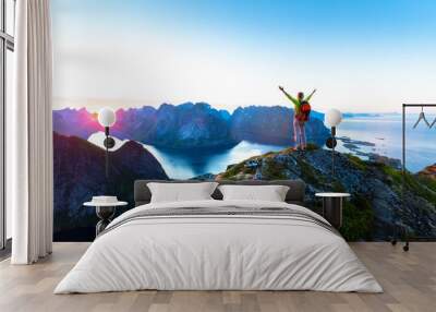 Hiker enjoying midnight sun during arctic summer, Reine, Lofoten, Norway Wall mural