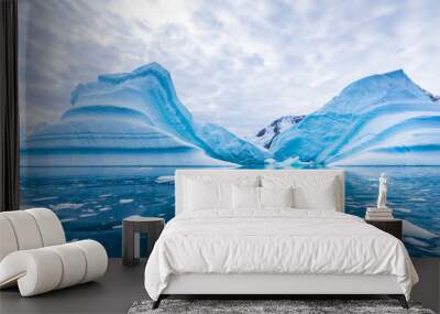 Iceberg in Antarctica floating in the sea, frozen landscape with massive pieces of ice reflecting on water surface, Antarctic Peninsula Wall mural