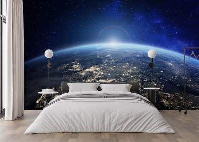 Planet Earth viewed from space with city lights in Europe. World with sunrise. Conceptual image for global business or European communication technology, elements from NASA Wall mural