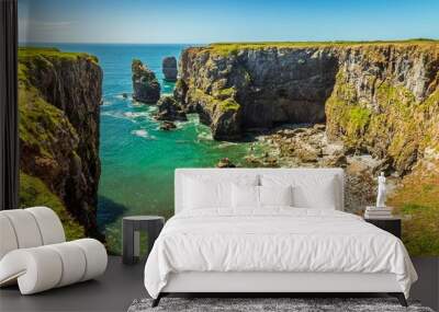 A circular bay with offshore stacks on the Pembrokeshire coast, Wales near Castlemartin in early summer Wall mural