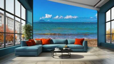 A view out to sea on a tranquil beach in St Kitts with the island of Sint Eustatius in the distance Wall mural