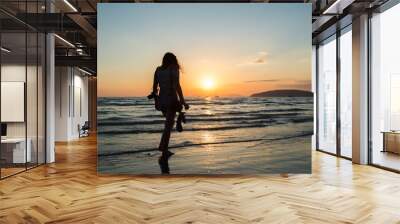 Girl walking and relaxing at sunset on a tropical beach in Thailand Wall mural