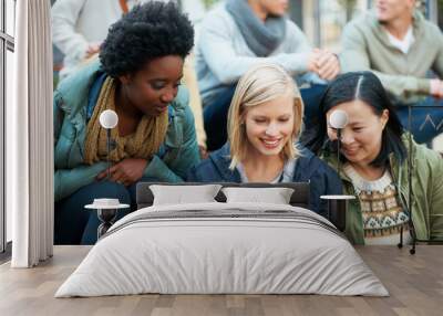 Look at this. Shot of a group of university students looking at something on a digital tablet. Wall mural