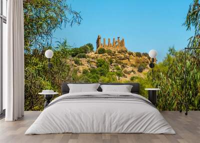 The Temple of Juno in the ancient Sicilian city of Agrigento viewed from the base of city ridge in summer Wall mural